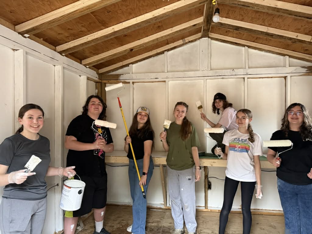 Teens getting to work on painting the future snack shack